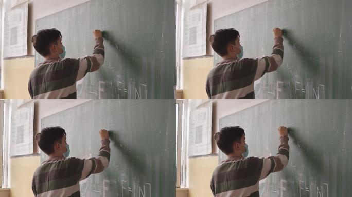 男生在黑板前写板书