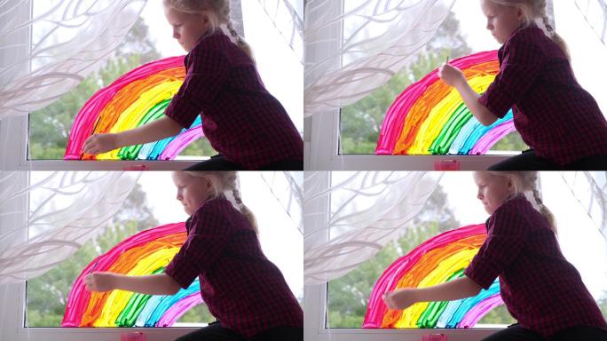 在玻璃上画彩虹的小女孩