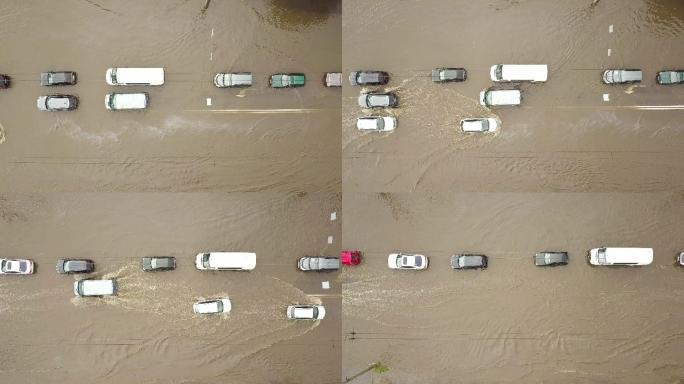 被雨水淹没的道路上行驶的交通车辆