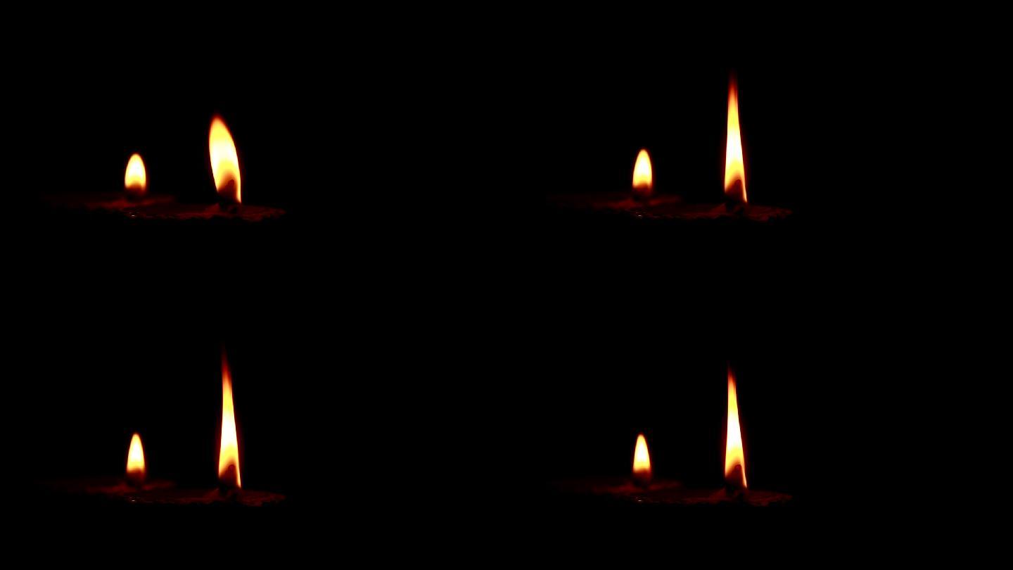 特写蜡烛在黑色背景上燃烧