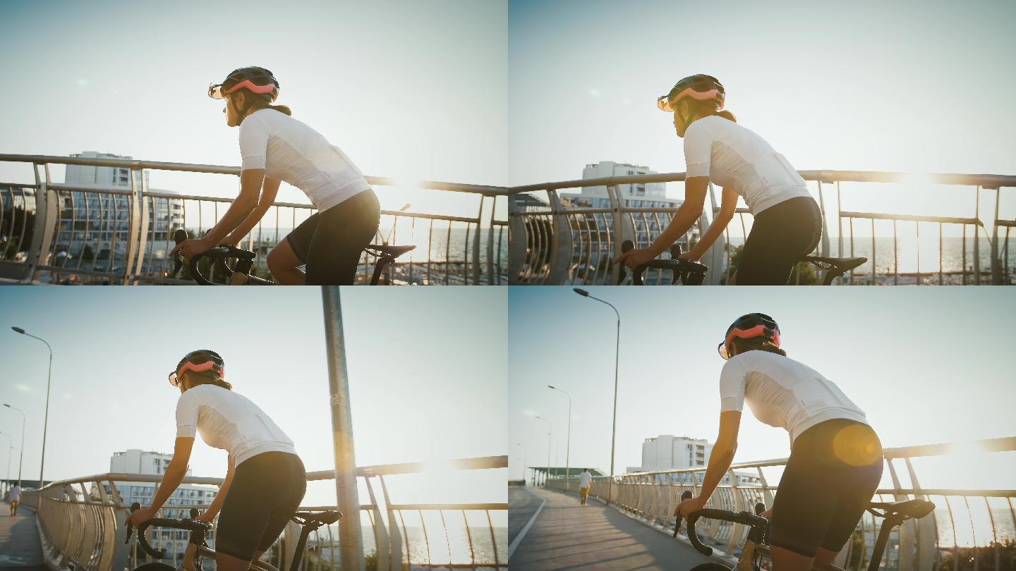 一位女运动员沿着海边的大桥骑着自行车