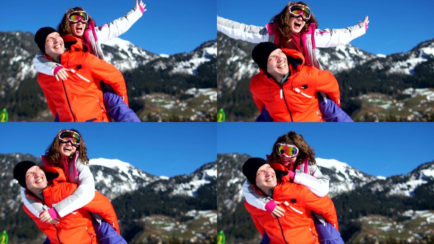 一对幸福的夫妇在山上看雪景