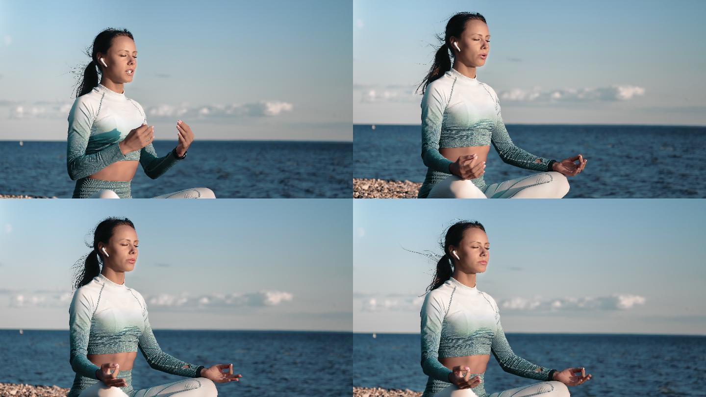 女士戴着耳机听音乐在海滩上练习瑜伽