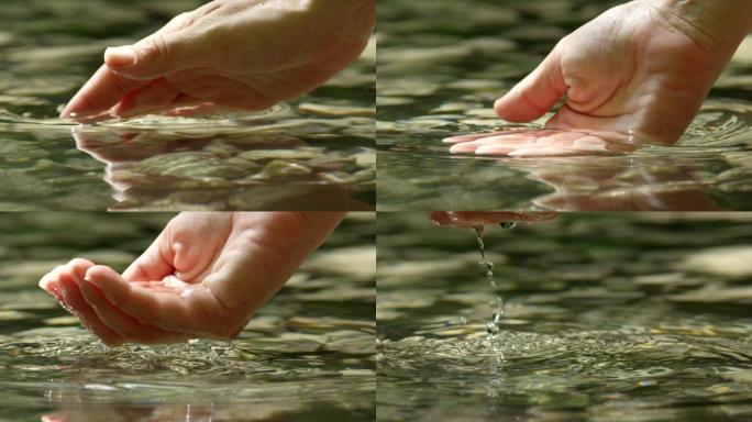慢镜头特写：用手抓取清澈的水