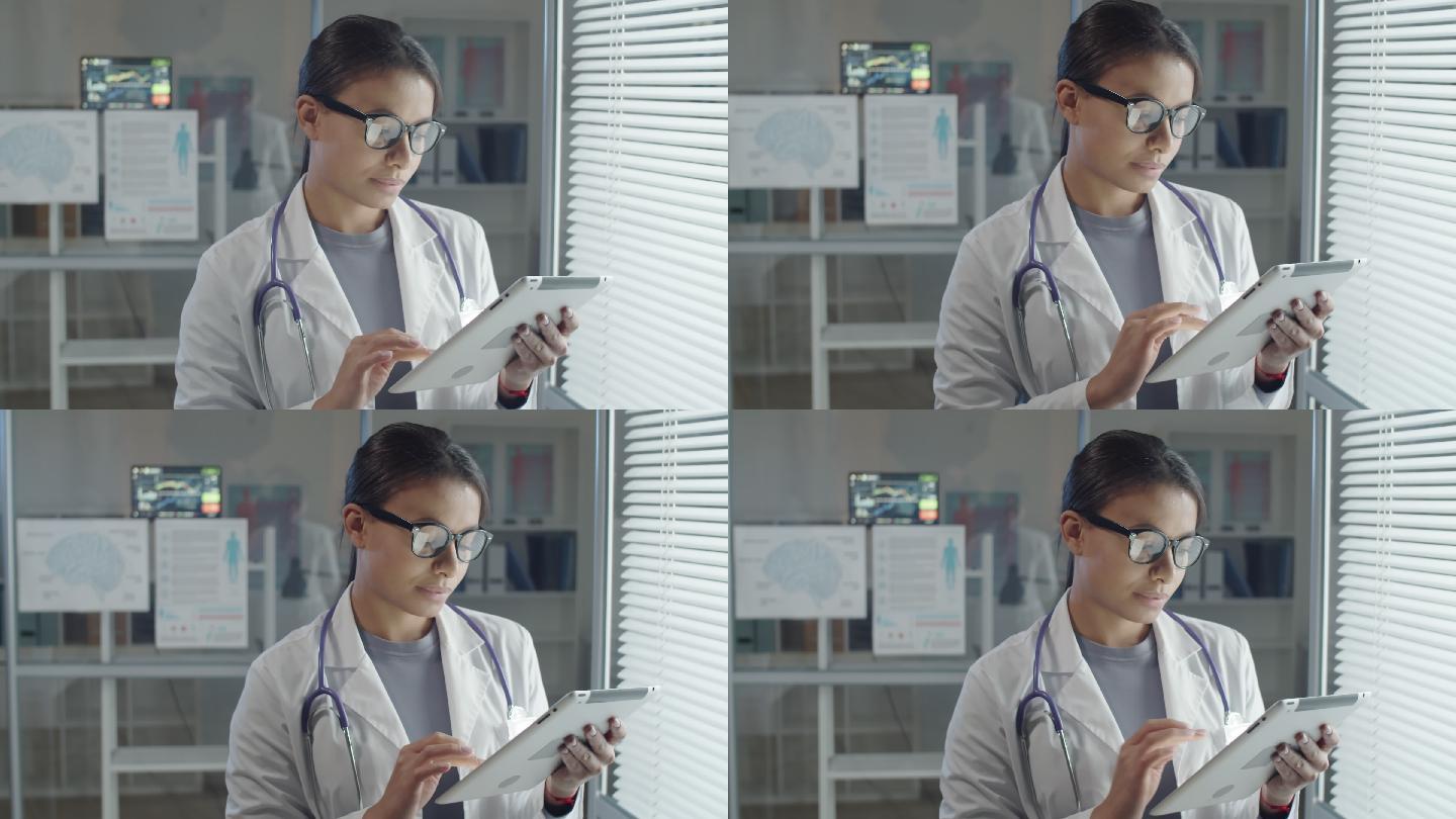 年轻女医生在数字平板电脑上浏览互联网