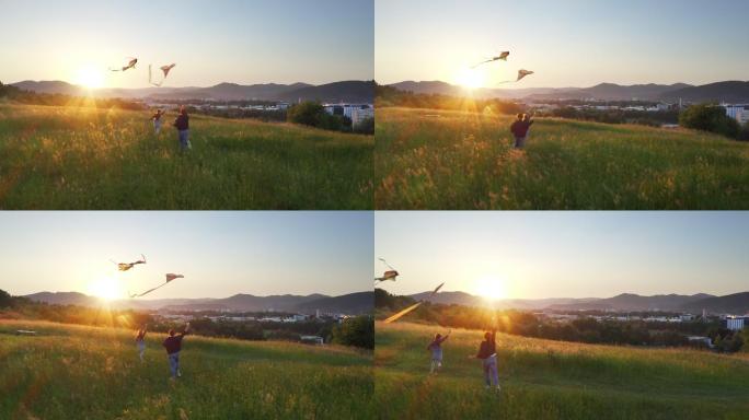 女儿和母亲在山上田野上放风筝。