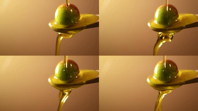 将橄榄油倒在放在勺子上的橄榄上