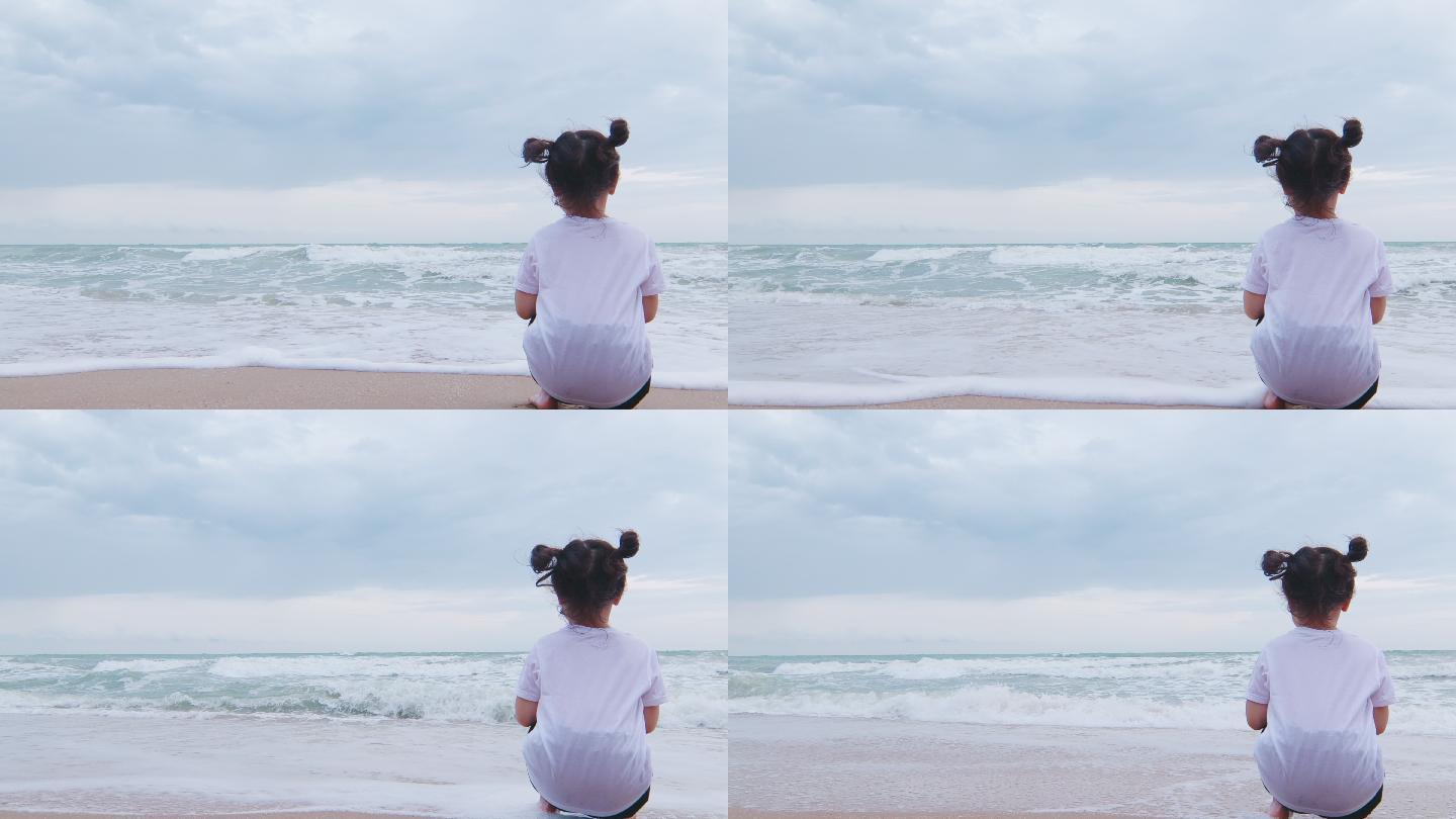 女孩坐在海边看着大海