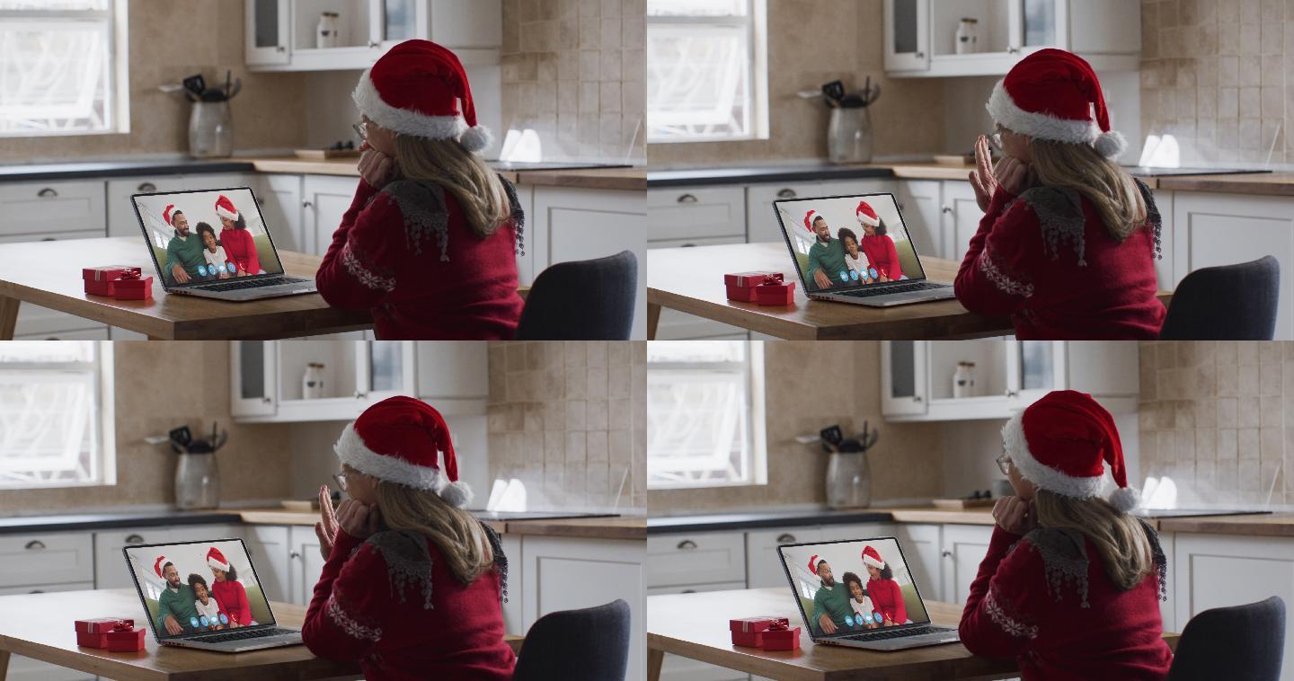 妇女戴着圣诞老人帽与亲友视频