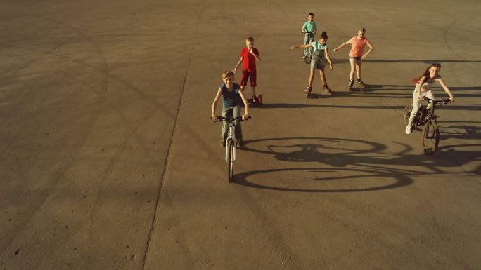 快乐的青少年骑自行车、溜冰和踏板车