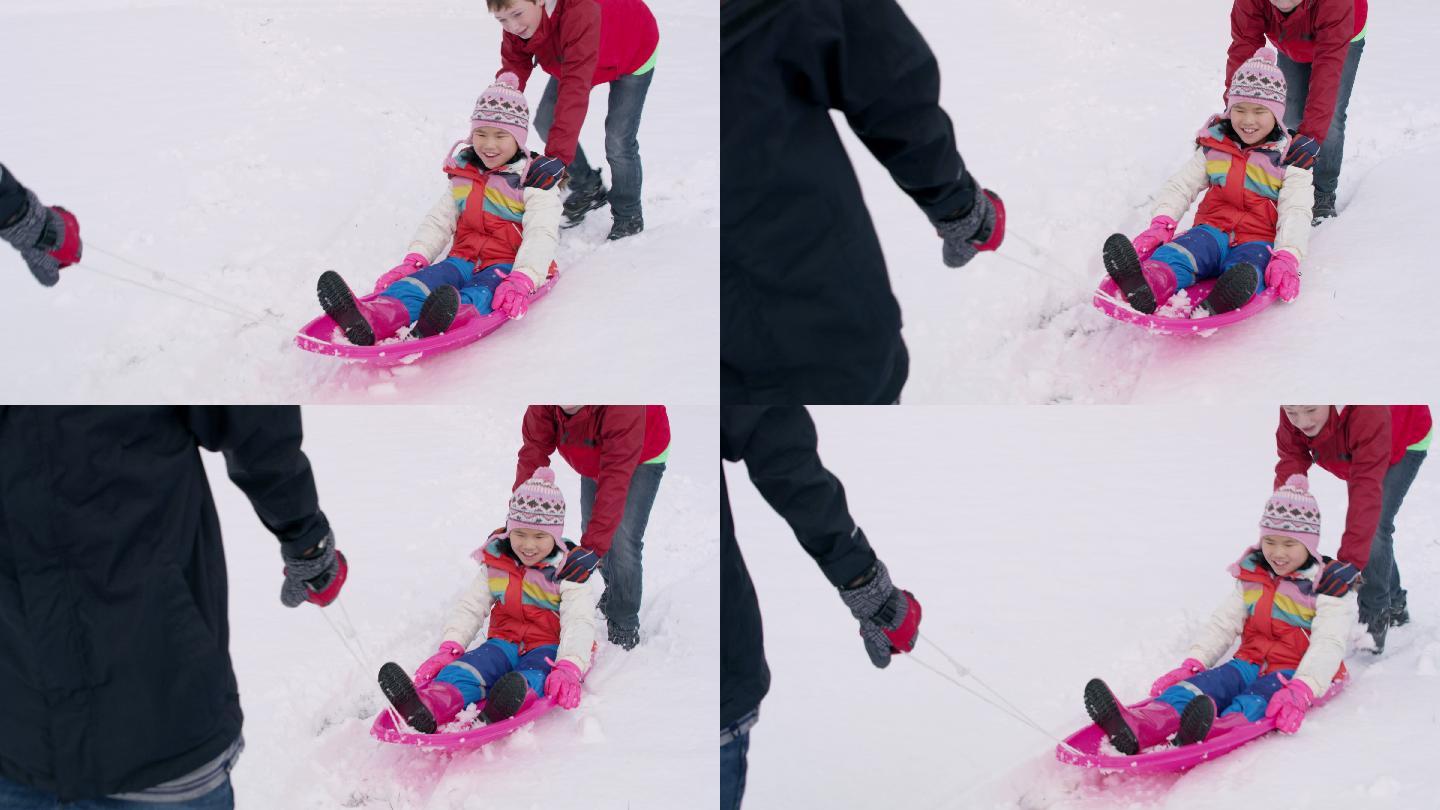 孩子们在冬天的雪地里玩和推雪橇