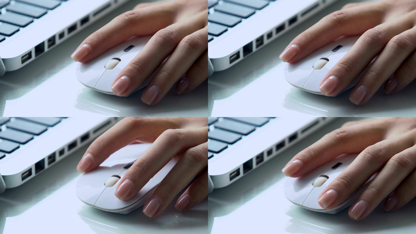 办公桌上使用无线电脑鼠标的女性