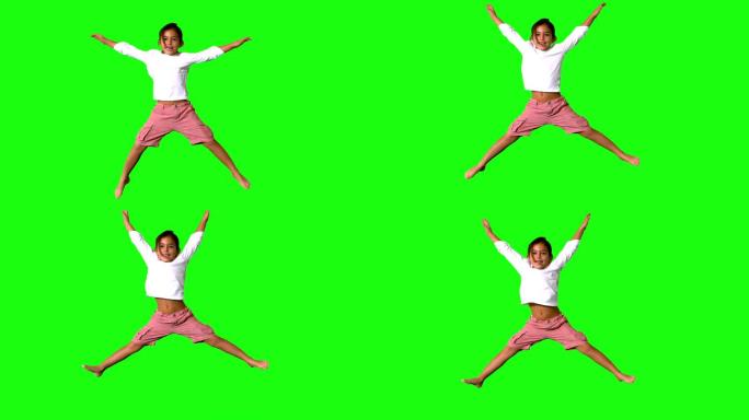 小女孩在绿色屏幕上跳跃