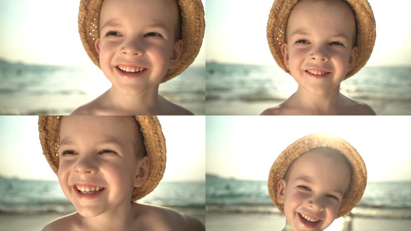 海滩上戴草帽的可爱男孩