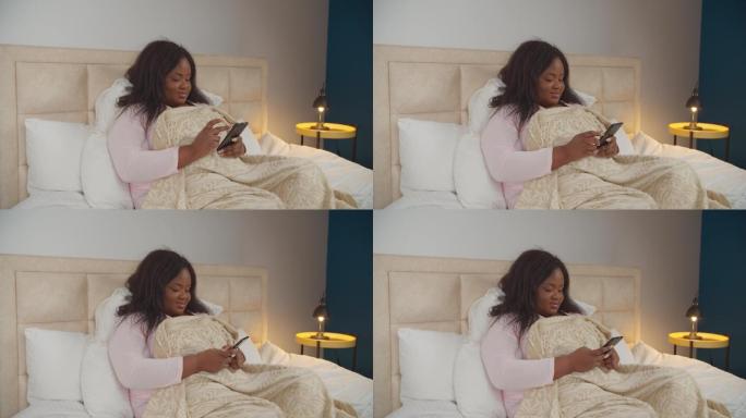 女性睡前在床上用手机上网