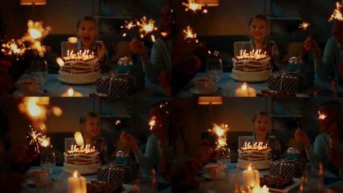 可爱的小女孩在餐桌旁庆祝生日。