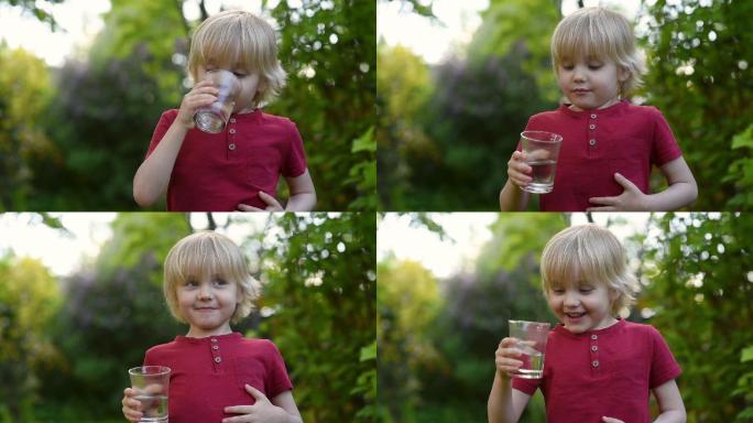 小男孩在后院或家中花园里喝一杯水