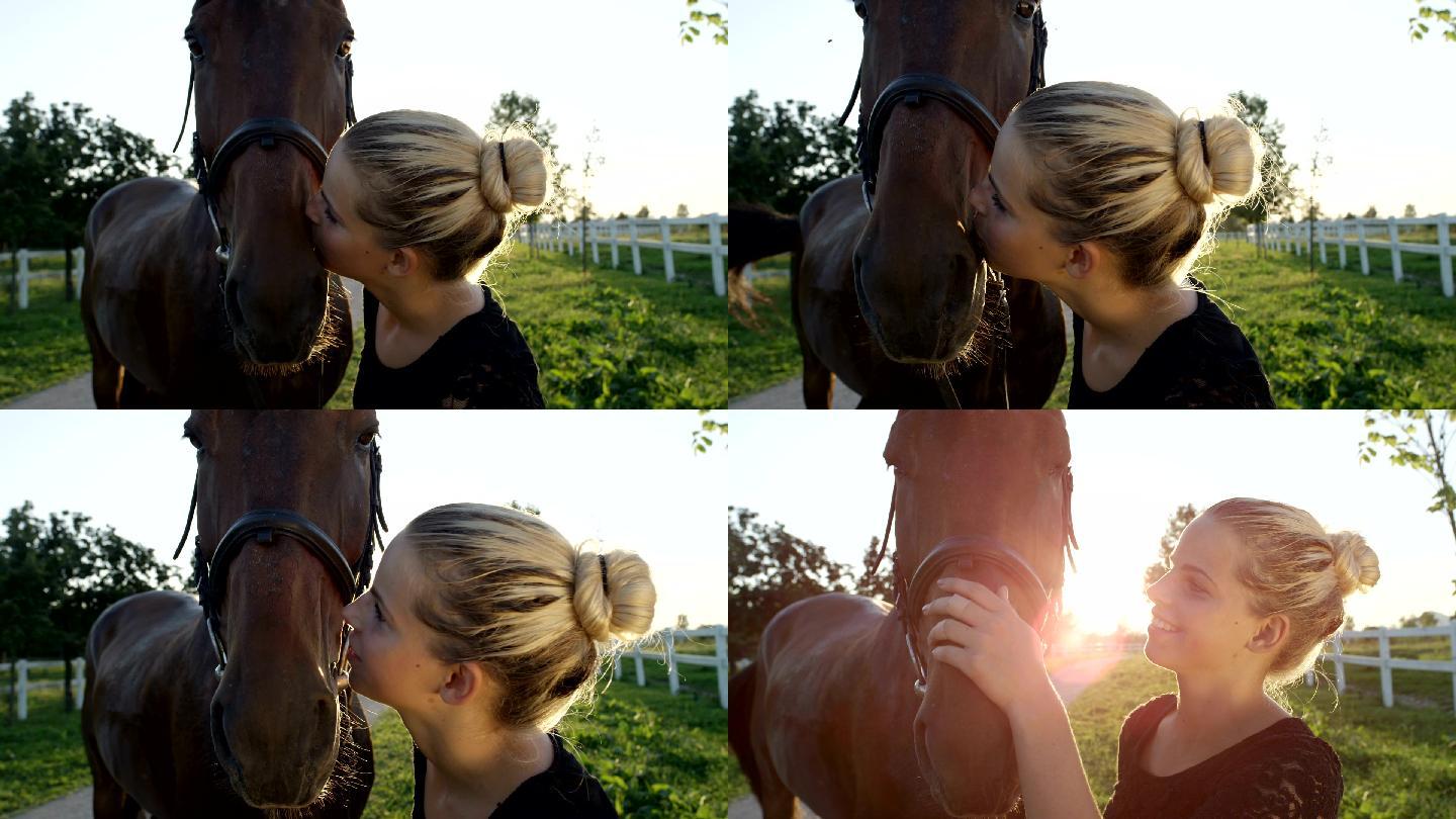 轻女孩亲吻和爱抚她强壮的深棕色马