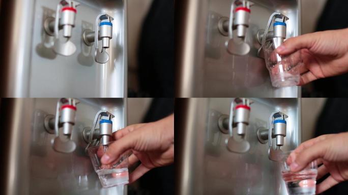 从饮水机将冷水接入玻璃中