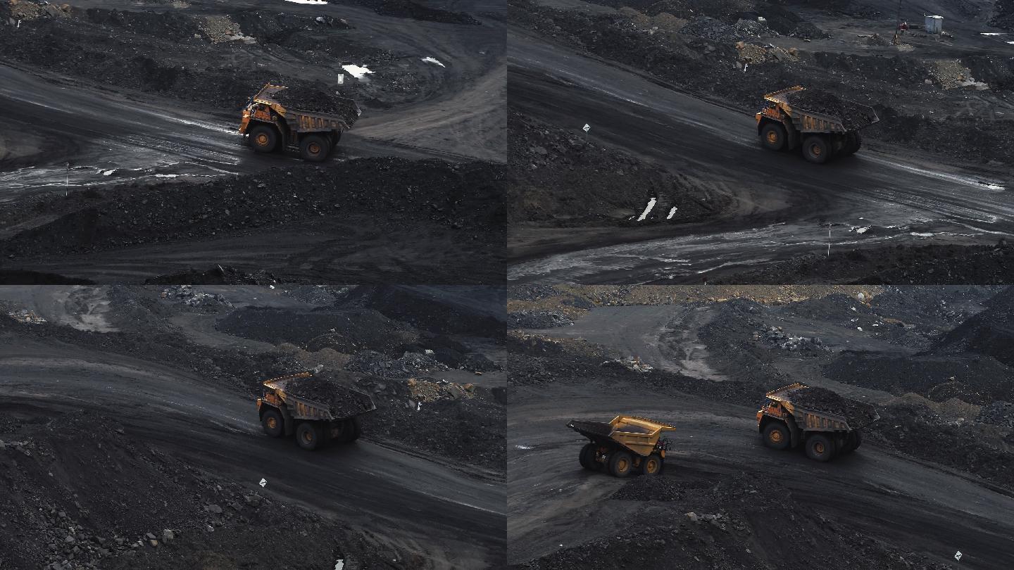 两辆巨型自卸卡车正在采石场运输煤炭