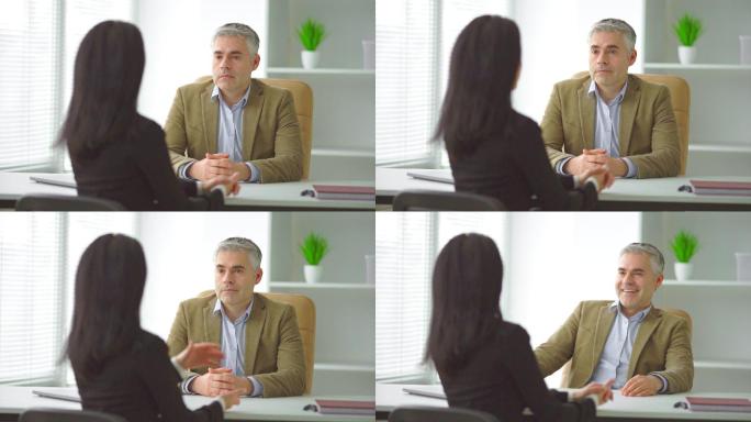 一个商人和一个女人在桌子旁谈话