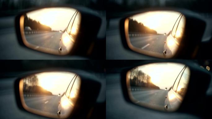 日落时后视镜中的道路视图