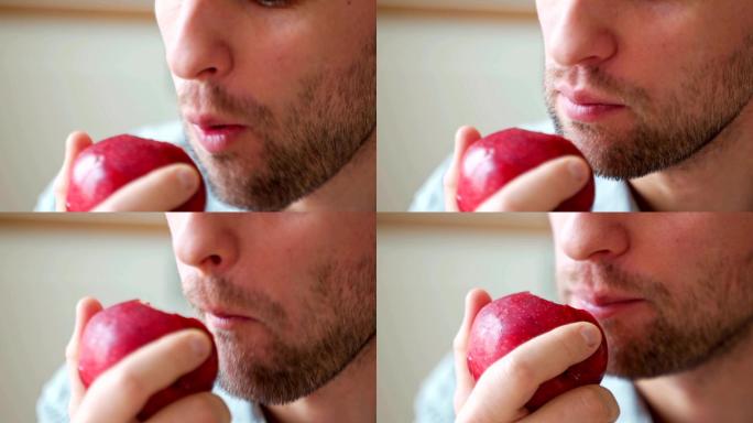 男性吃红苹果的特写