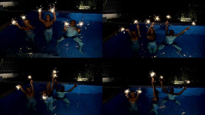 泳池中玩烟花的朋友们
