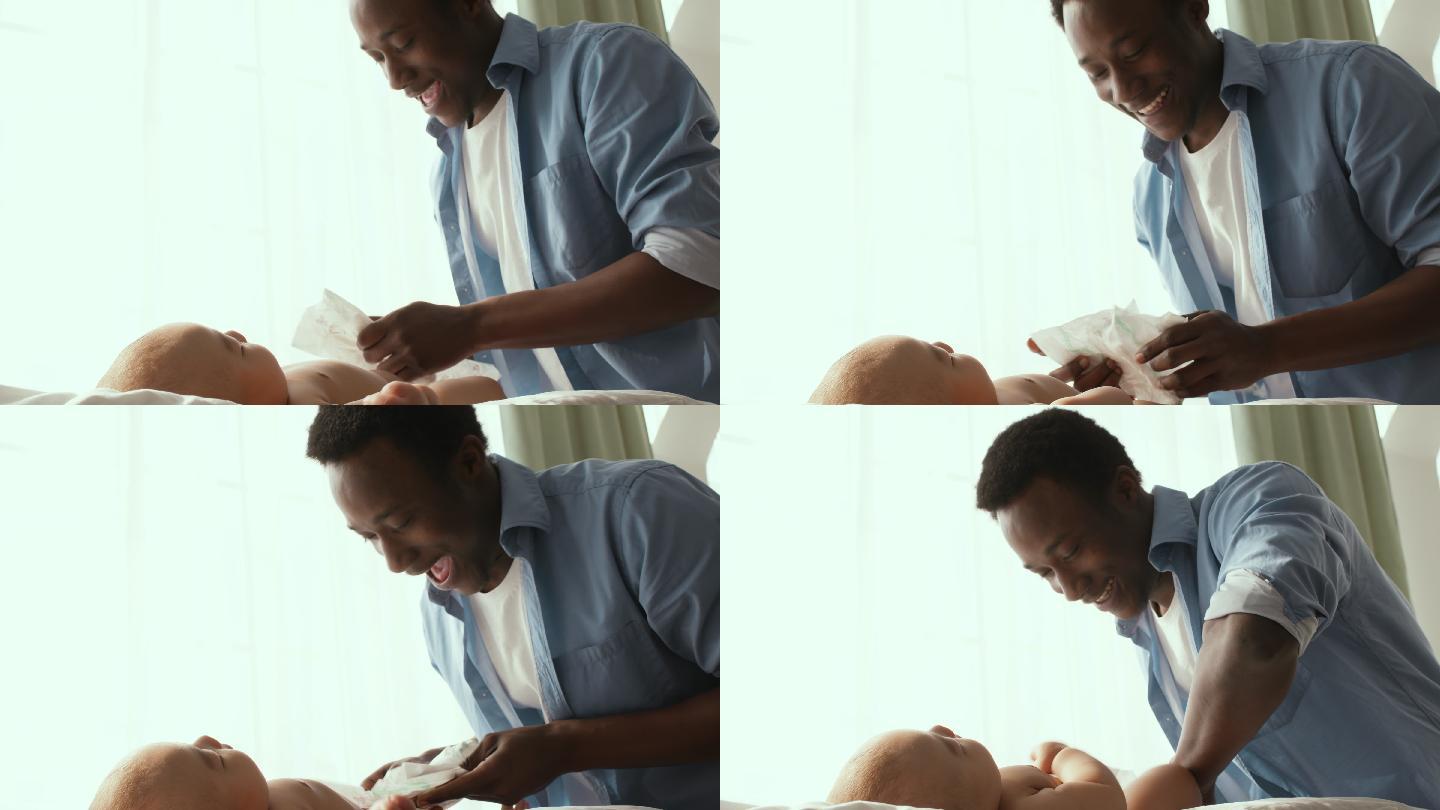 父亲正在为他的新生婴儿换尿布