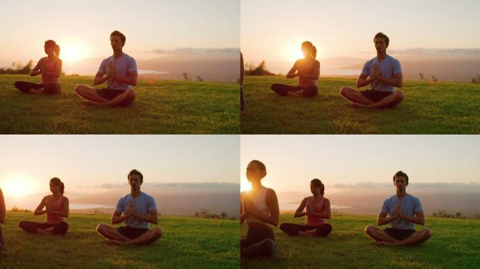 年轻人在日落时一起联系瑜伽