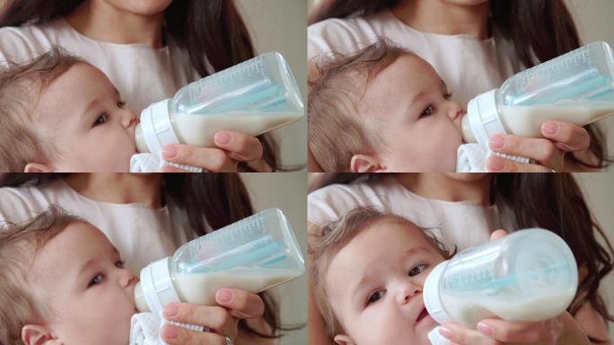母亲在家用奶瓶喂男婴