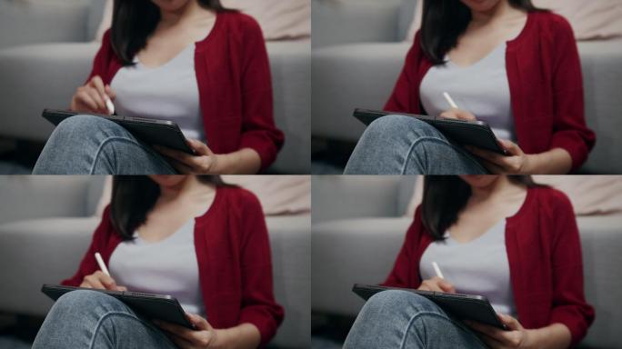 女性用触控笔在平板电脑上画画。