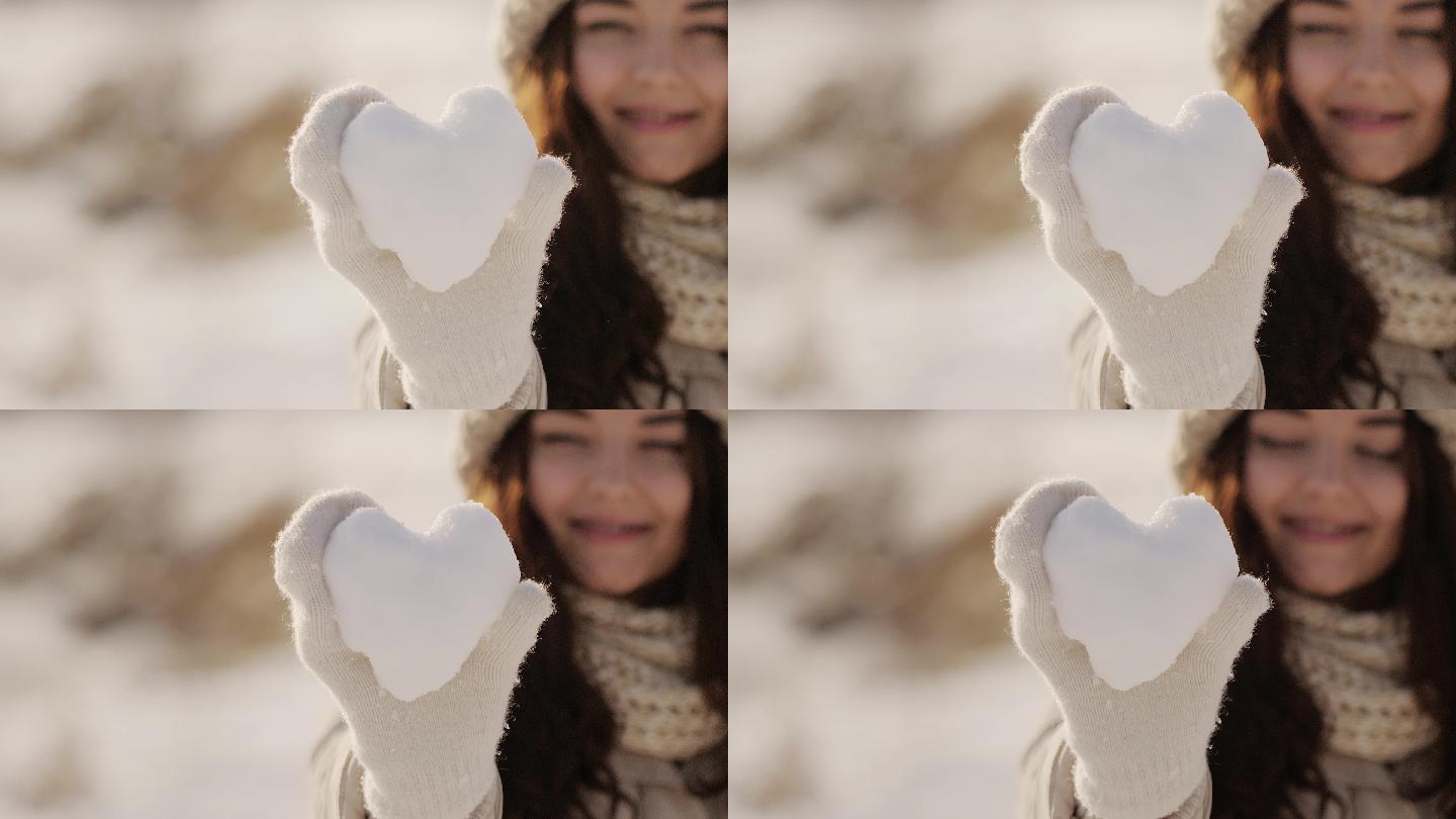 一个女人手里拿着一颗雪做的心