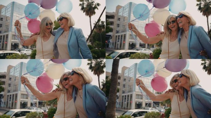 快乐女性在城市里牵着气球相互拥抱