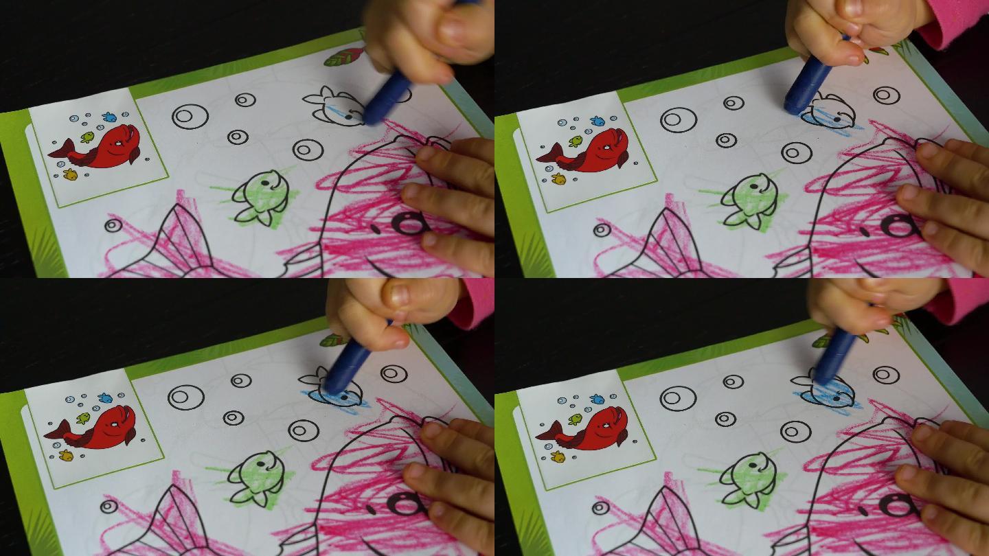 一个三岁的孩子用彩色蜡笔涂色