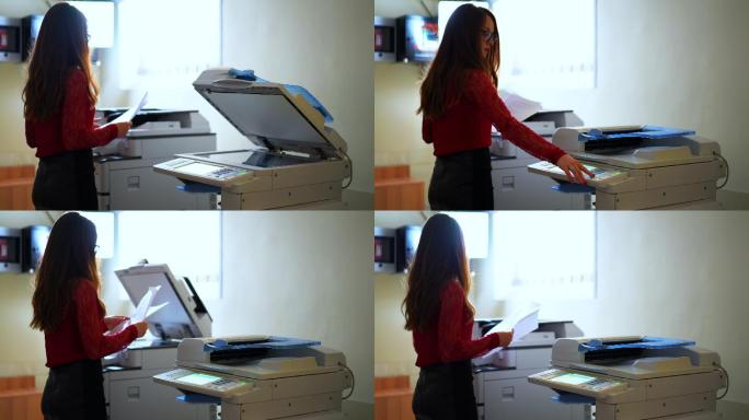 女商人使用激光打印机复印文件。