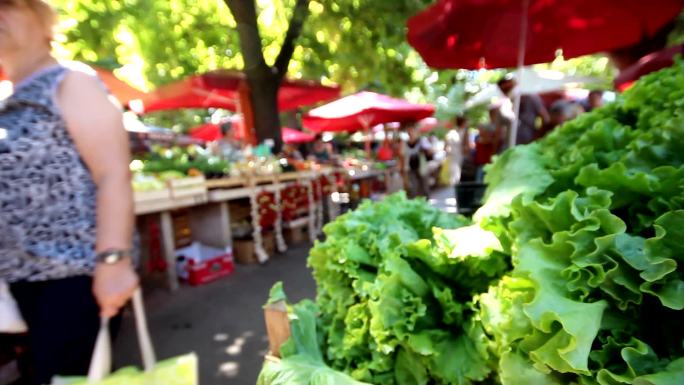 人们在普拉的绿色市场购买蔬菜。