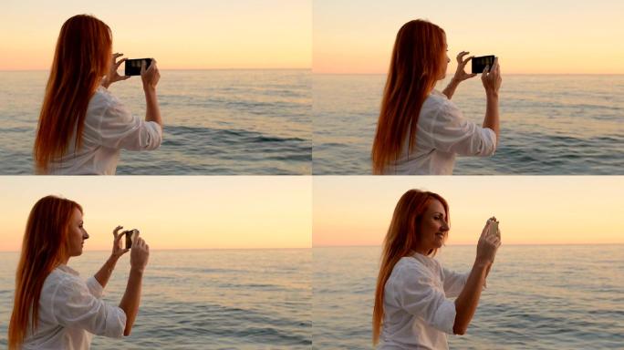 年轻女子正在用手机摄像头拍摄海景