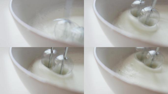 用打蛋器将鸡蛋和糖打到奶油搅拌器中。