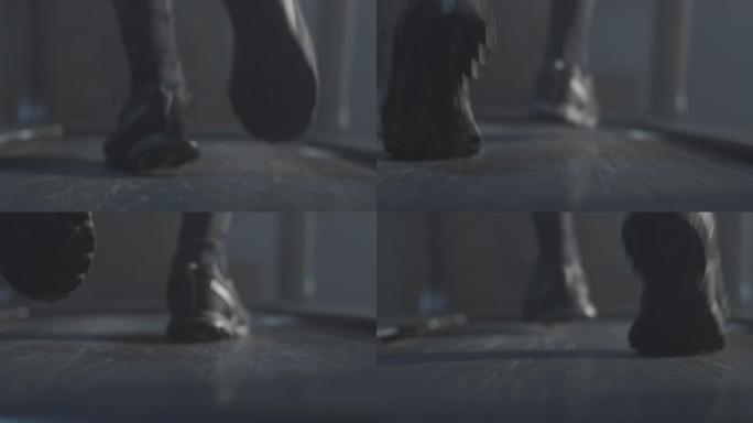 在跑步机上跑步时的男性脚的后视图特写。