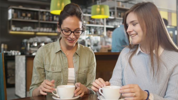 两个年轻女人在咖啡馆聊天