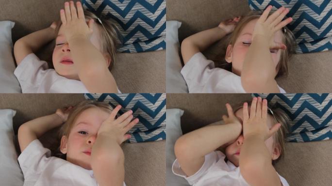 一个小女孩在醒后用手揉眼睛