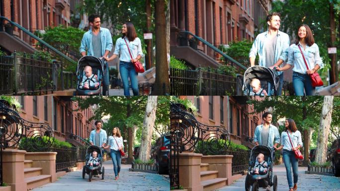 一对夫妇带着婴儿车走在街上