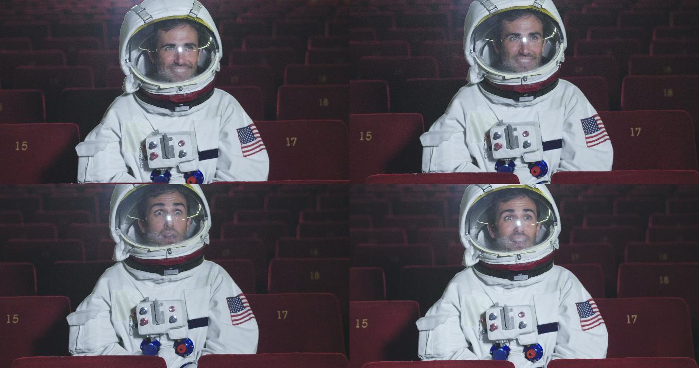 一名宇航员一边吃爆米花一边看电影。
