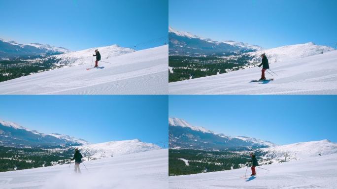 一名女性滑雪者沿着滑雪坡滑下