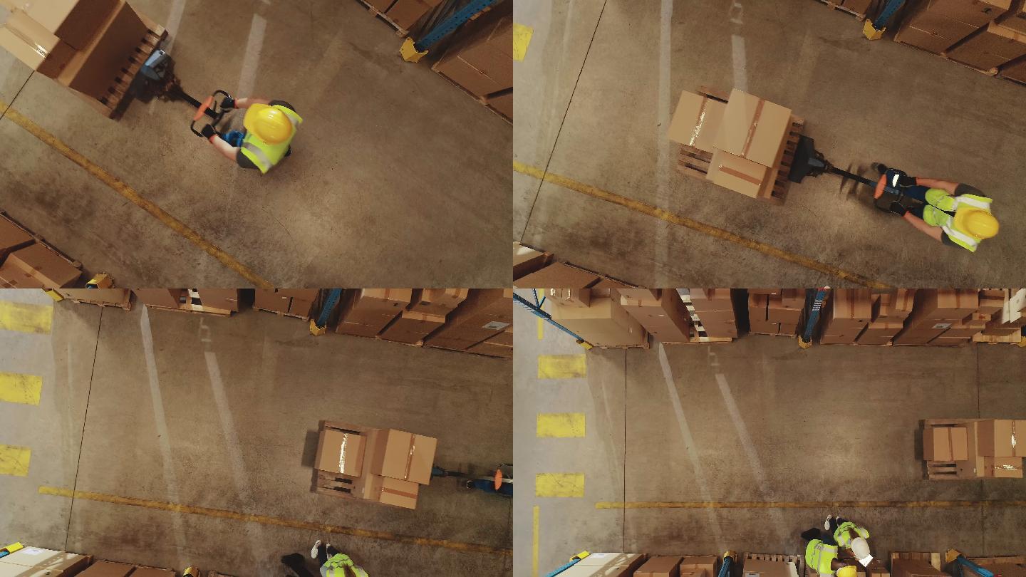 工人使用手动托盘车移动纸板箱