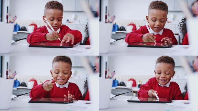 学童在幼儿学校使用平板电脑和手写笔画画