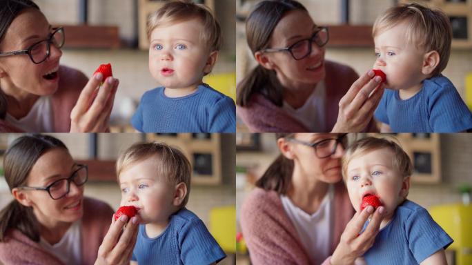 母亲给小儿子吃草莓