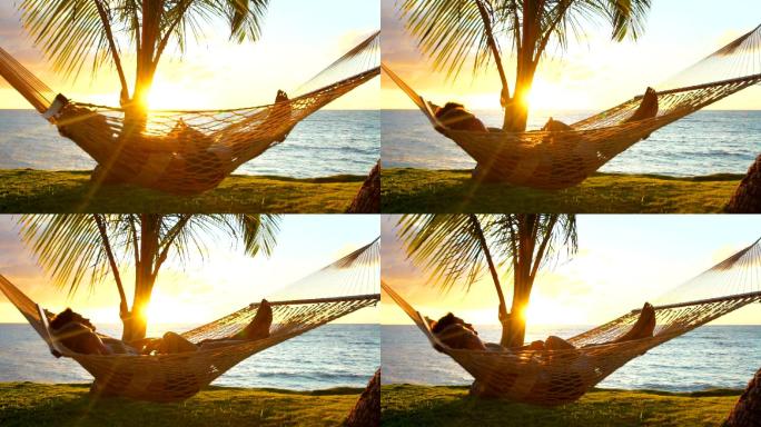 一对浪漫的情侣在热带吊床上放松。