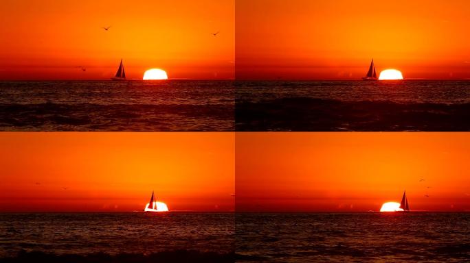 橙色日落时帆船行驶在海上